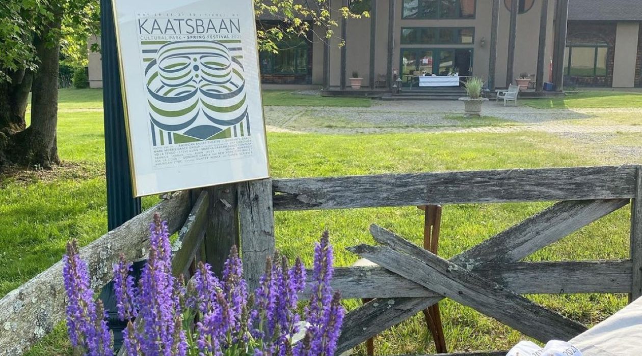 The entrance of Kaatsbaan Cultural Park in Tivoli with beautiful purple flowers in front.